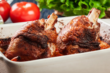 Roasted turkey knuckle with potatoes and vegetable