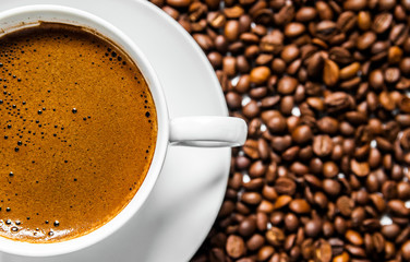 Coffee cup and coffee beans on table, top view, love coffee, Brown coffee beans isolated on white background, Hot Coffee cup with Coffee beans