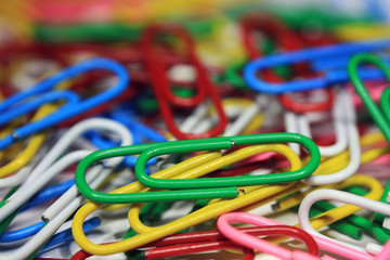 Lots of colorful abstract paper clips close up