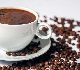 Coffee cup and beans on a white background.