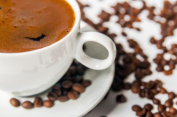 Coffee cup and beans on a white background.