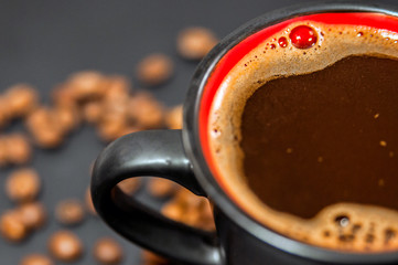 Style big black cup of coffee isolated on black background