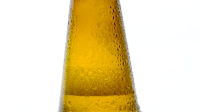 Bottle of beer with water drop falling