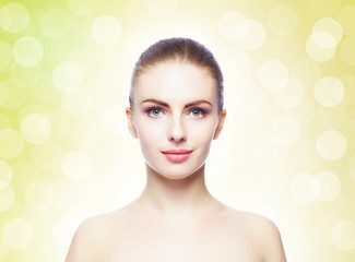 Naklejka premium Portrait of young, beautiful and healthy woman: over yellow background. Healthcare, spa, makeup and face lifting concept.