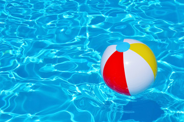 Colorful inflatable ball floating in swimming pool