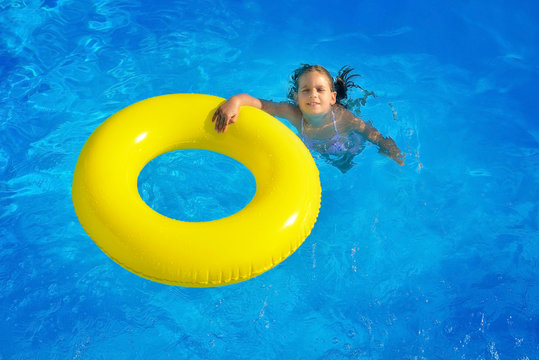 Adorable toddler relaxing in swimming pool