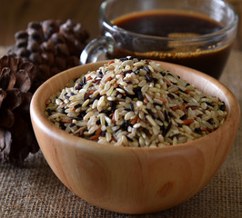 Brown rice seed in bowl wood
