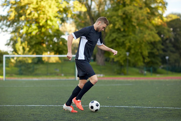 soccer player playing with ball on football field