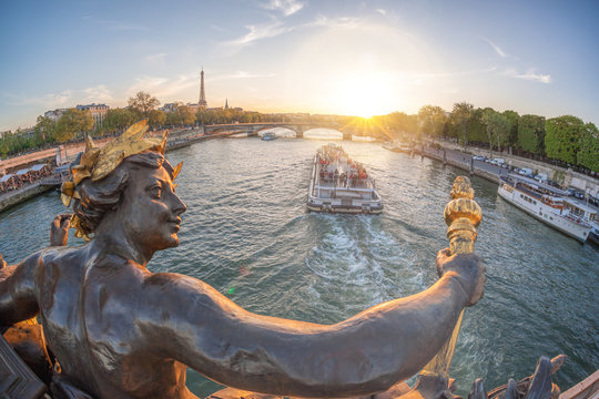 Alexandre III bridge in Paris against Eiffel Tower with boat on Seine, France