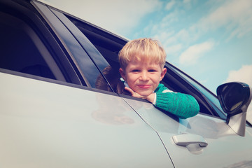 happy little boy loves travel by car