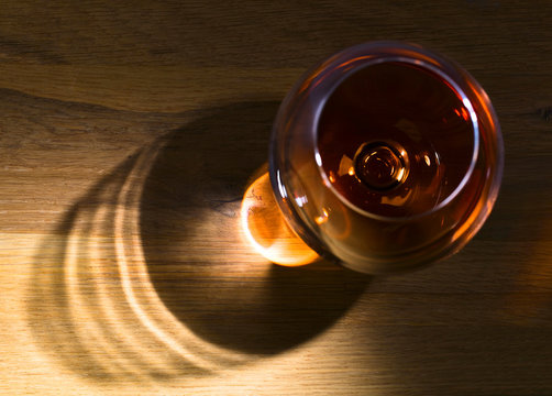 Snifter of brandy on a wooden table