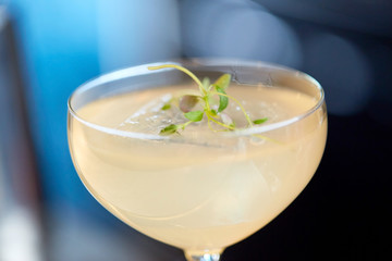 close up of glass with cocktail at bar