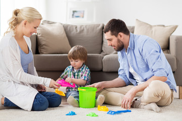 Obraz na płótnie Canvas happy family playing with beach toys at home