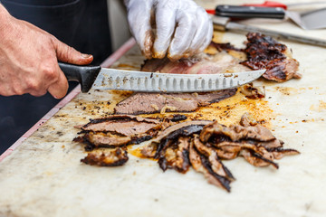 Chef slicing grilled beef steak