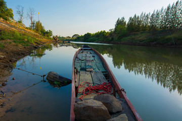 Old wooden fishing boat trawler on river.