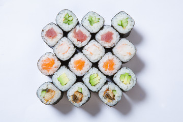 A plate with different kinds of sushi and rolls