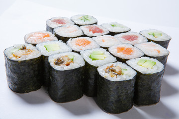 A plate with different kinds of sushi and rolls
