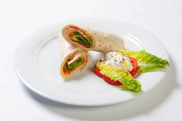 Rolls from pita bread stuffed with salad cheese ham and vegetables