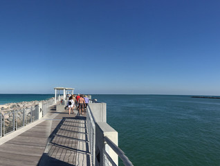 MIAMI, FL - FEBRUARY 2016: Tourists along South Pointe Park Wooden Pier. Miami attracts 15 million people annually