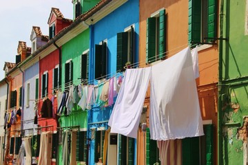 
Bright colored houses and laundry hung up to dry on the island Burano, situated in the Lagoon of Venice, Italy, Europe. 

