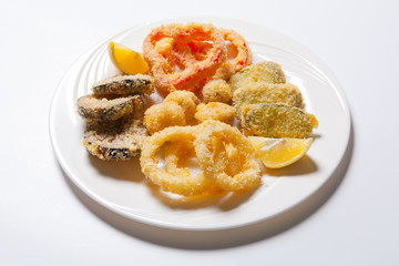 vegetables in batter. Onion rings, pepper eggplant zucchini and lemon