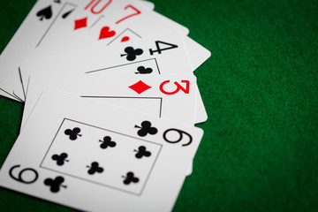 poker hand of playing cards on green casino cloth