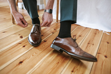 groom tying his shoes