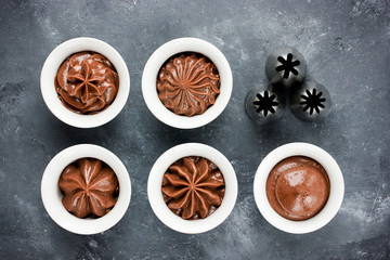 Chocolate frosting swirls and various metal confectionery nozzles for decorating capcasks