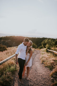 Young couple walking along dirt path