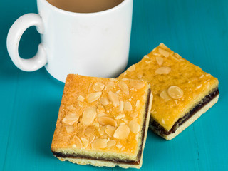 Cherry Bakewell Tarts With a Cup or Mug of Tea or Coffee