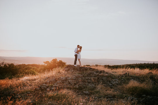 couple kissing on field