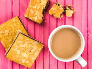 Cherry Bakewell Tarts With a Cup or Mug of Tea or Coffee