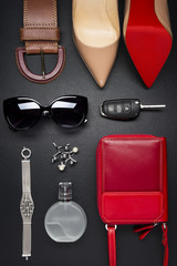 Woman accessories, clothing, jewelry, shoes in red color on leather black background, lifestyle, modern female concept, fashion industry - 147953009