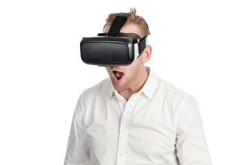 Man in a white shirt wearing a VR glasses, standing against a white background with his mouth wide open.