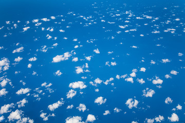Clouds and blue sea view from aircraft. Clouds top view from airplane.