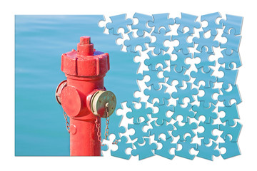 Manage your fire prevention plan - Red fire hydrant against a water background  - concept image in...