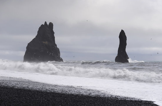 Iceland, Vik, stone trolls at Reynisfjara beach