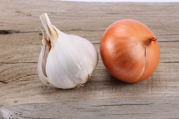 spices onion and garlic on old wood background