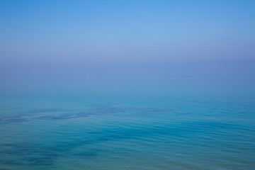 Sea and sky without horizon at sunrise. Background with the ocean view.
