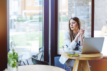 Beautiful Young Woman Sitting in Coffee Shop