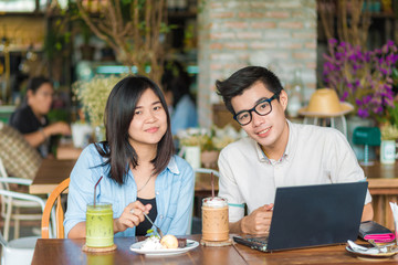 Two young business having a successful co-working at vintage restaurant.