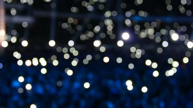 Bokeh background of crowd with lights at the concert