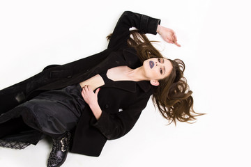 attractive girl with beautiful hairstyle in coat has black makeup