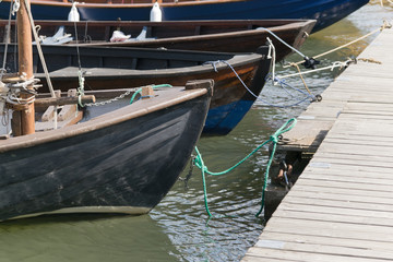 Close up of boats docked at pier at the see port in Finland.