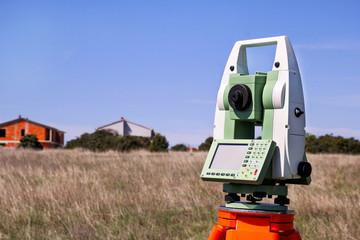 Total station. Survey Instrument geodetic device. Fall time land surveying, total station set in the field.