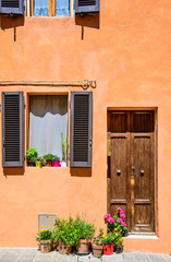 Typical italian door and window with flowers,Tuscany, Italy.