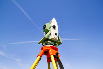 Total station with blue sky in the background. Survey Instrument geodetic device, total station set...