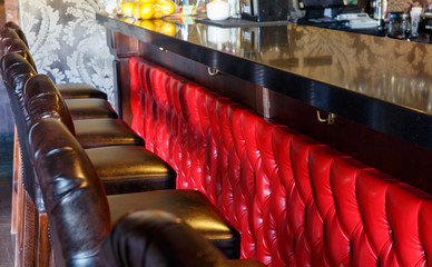 Row of red chairs near bar counter