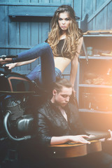 Fototapeta na wymiar Biker couple in love in garage
