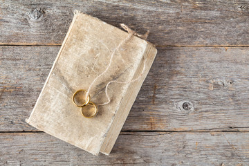 Two wedding rings with a bible